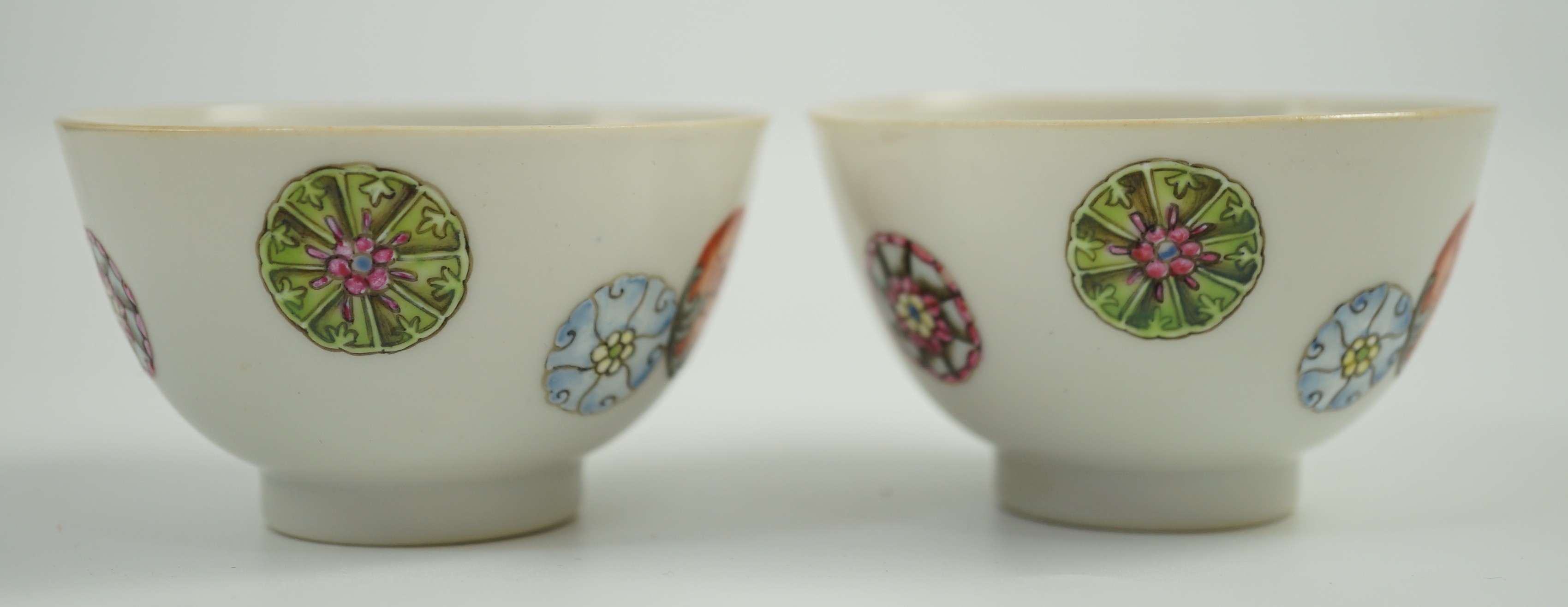 A pair of Chinese enamelled porcelain tea bowls, Qianlong seal marks, 7cms diameter